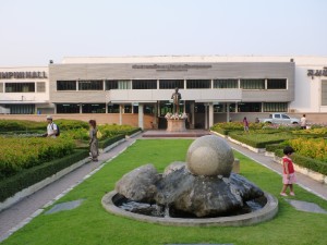 Music hall in the park with sculpture and statues outside.