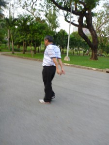 Slacks, polo shirt, sneakers. Walking hard and vigorously moving arms.